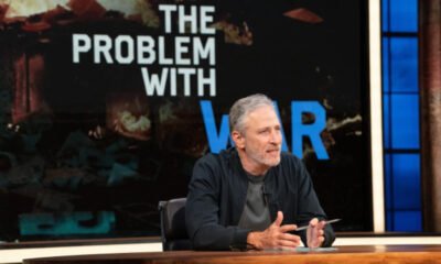A photo of Jon Stewart at a newsdesk