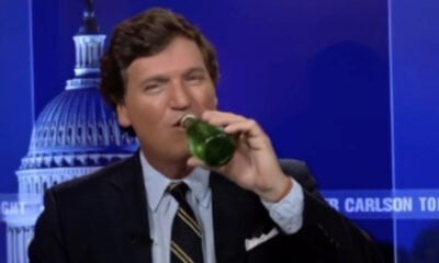A photo of Tucker Carlson drinking a beer